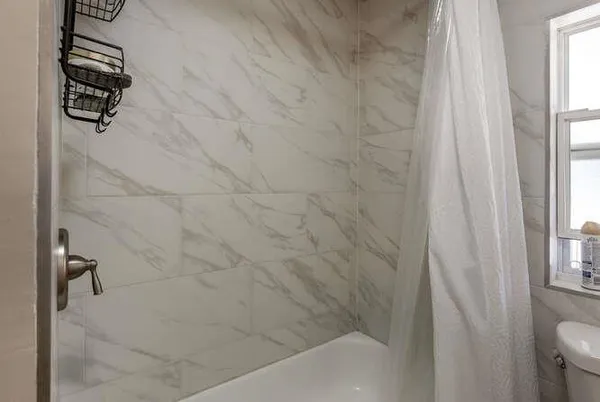 a bathroom with a bathtub and shower