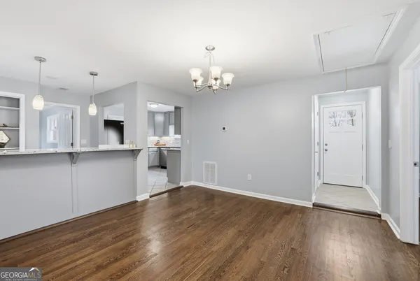 a view of kitchen with granite countertop cabinets and wooden floor