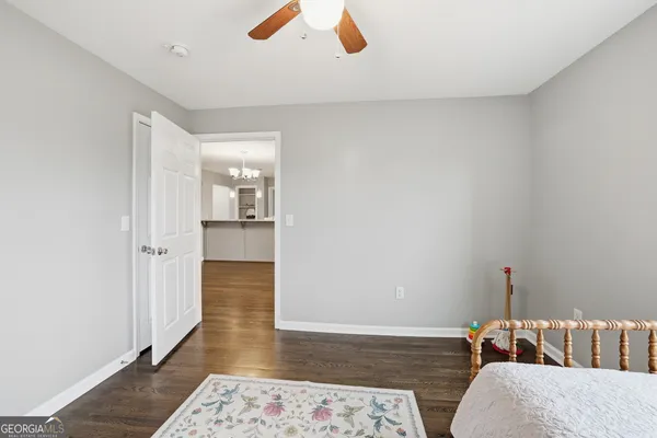a bedroom with furniture and wooden floor