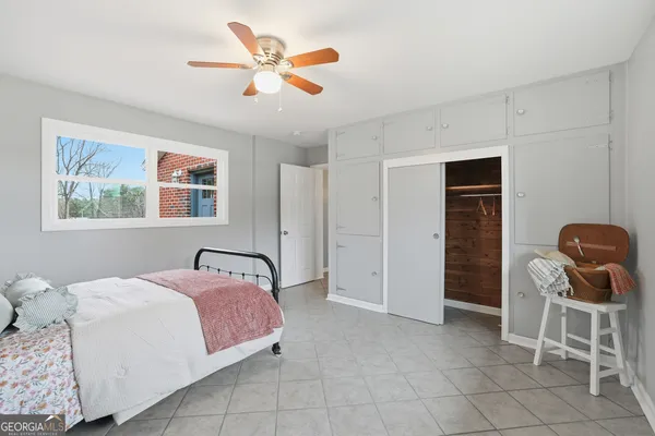 a bedroom with a bed and chair