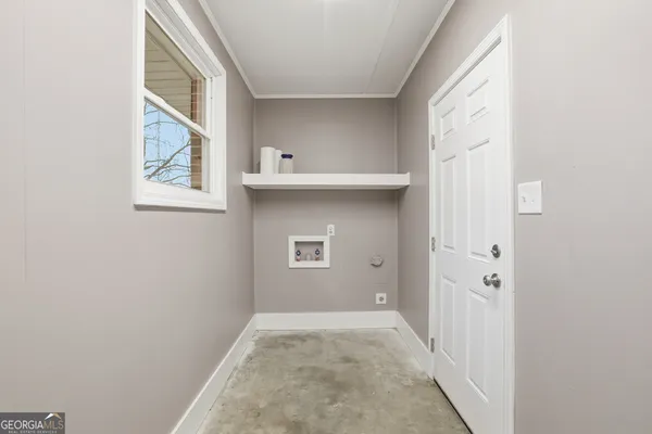 a view of an empty room with windows