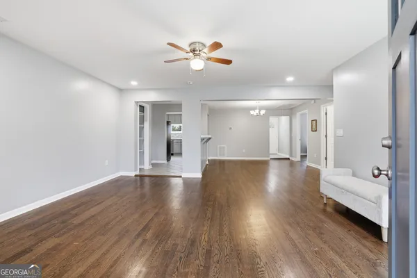 a view of an empty room with wooden floor and a cabinet