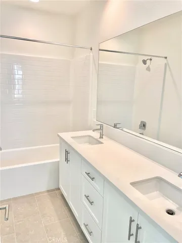 a bathroom with a tub sink and mirror