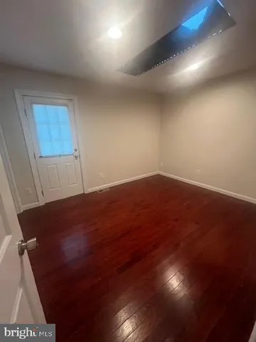 an empty room with wooden floor