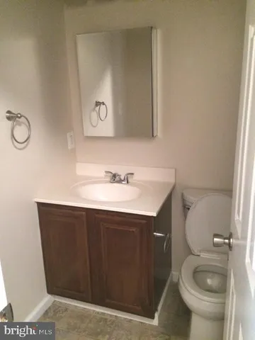 a bathroom with a sink vanity and toilet