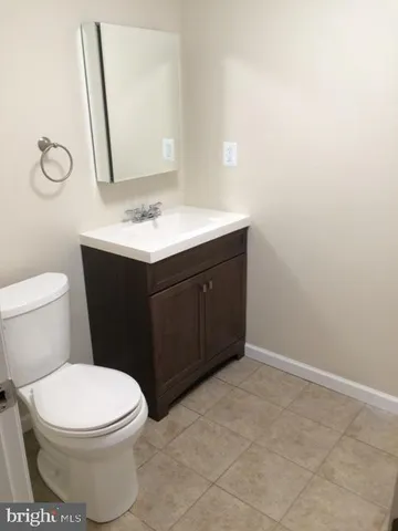 a bathroom with a sink vanity and toilet