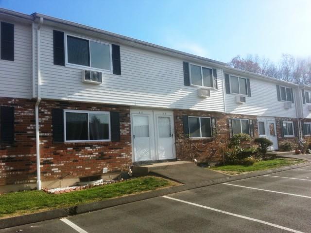 461 Spring Street, Unit 5C Naugatuck, CT 06770 - Photo 1 of 1 a front view of a house with a garden