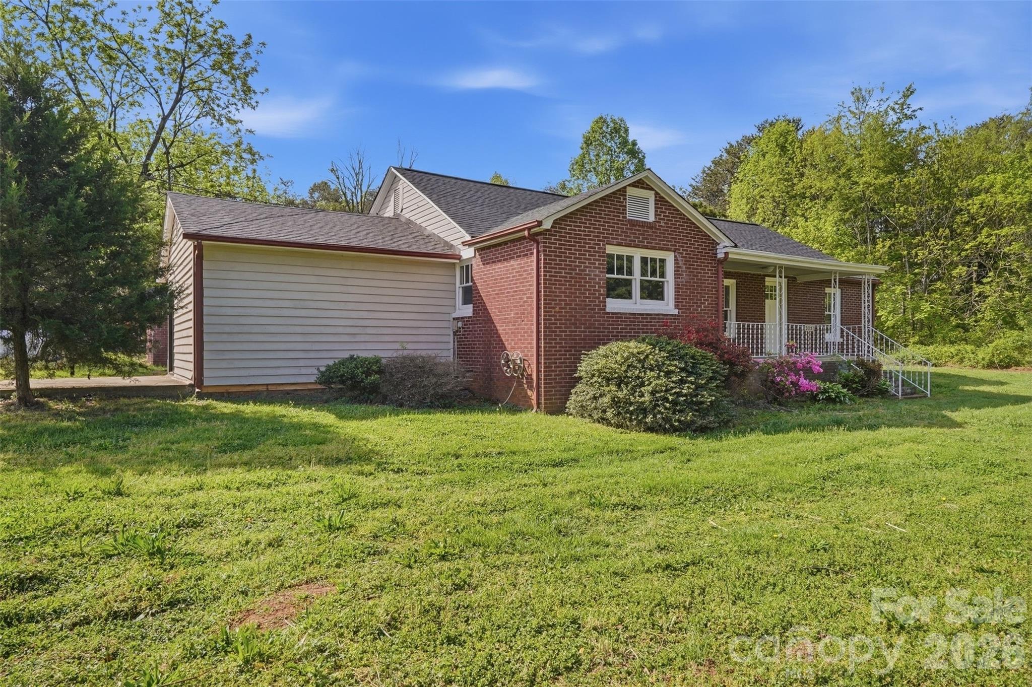 2231 Claremont Road Newton, NC 28658 - Photo 36 of 39 a view of a yard in front of a house with large windows