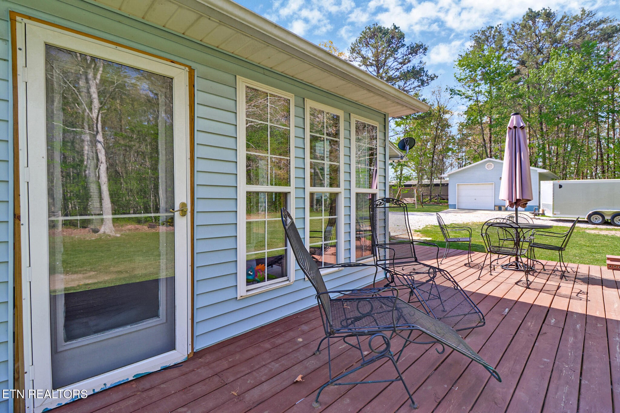 220 Old Gatewood Ford Road Jamestown, TN 38556 - Photo 12 of 57 a patio with wooden floor and outdoor seating
