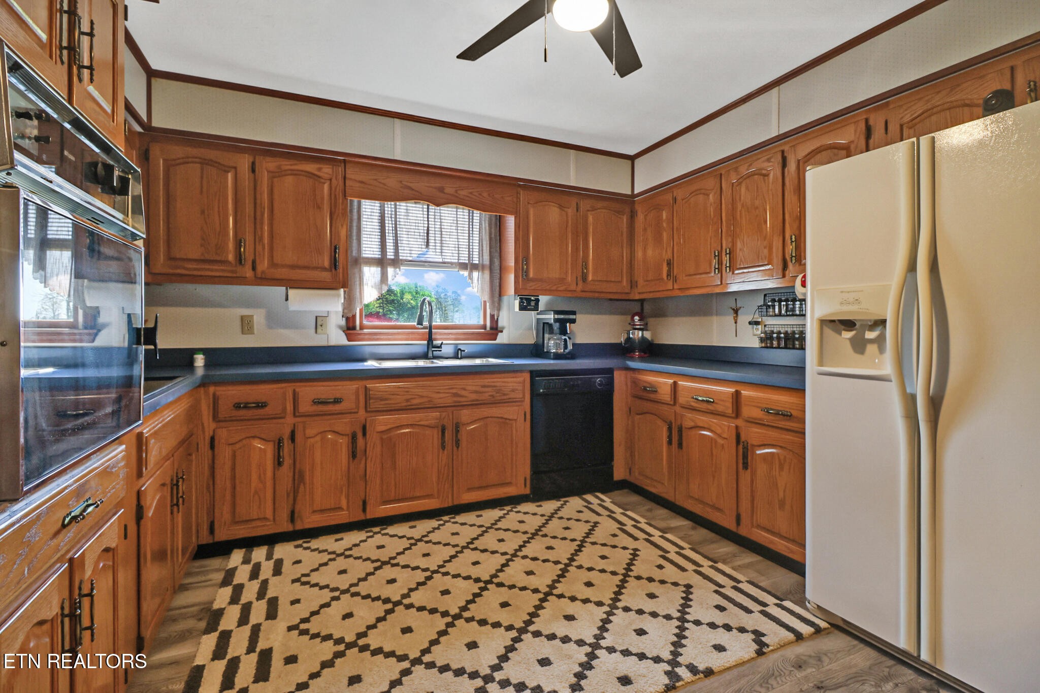 220 Old Gatewood Ford Road Jamestown, TN 38556 - Photo 25 of 57 a kitchen with stainless steel appliances granite countertop a refrigerator sink and cabinets