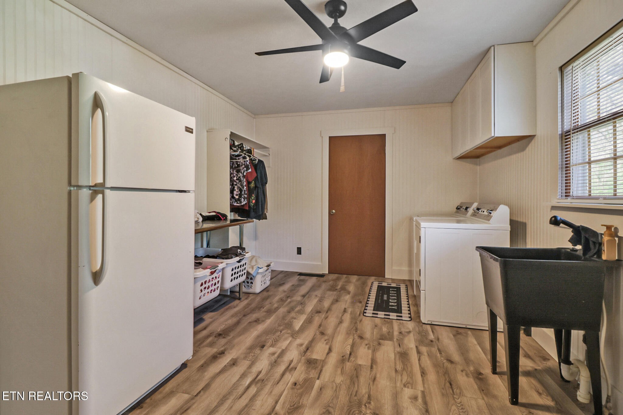 220 Old Gatewood Ford Road Jamestown, TN 38556 - Photo 28 of 57 a kitchen with a refrigerator a sink dishwasher a dining table and chairs with wooden floor