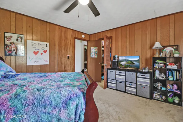 a bedroom with a bed dresser and a window
