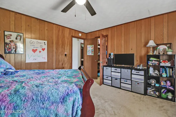 a bedroom with a bed and a dresser
