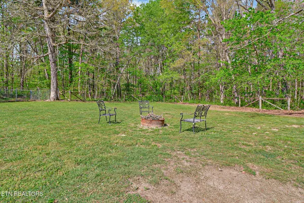 a view of a chairs and table on the wooden deck