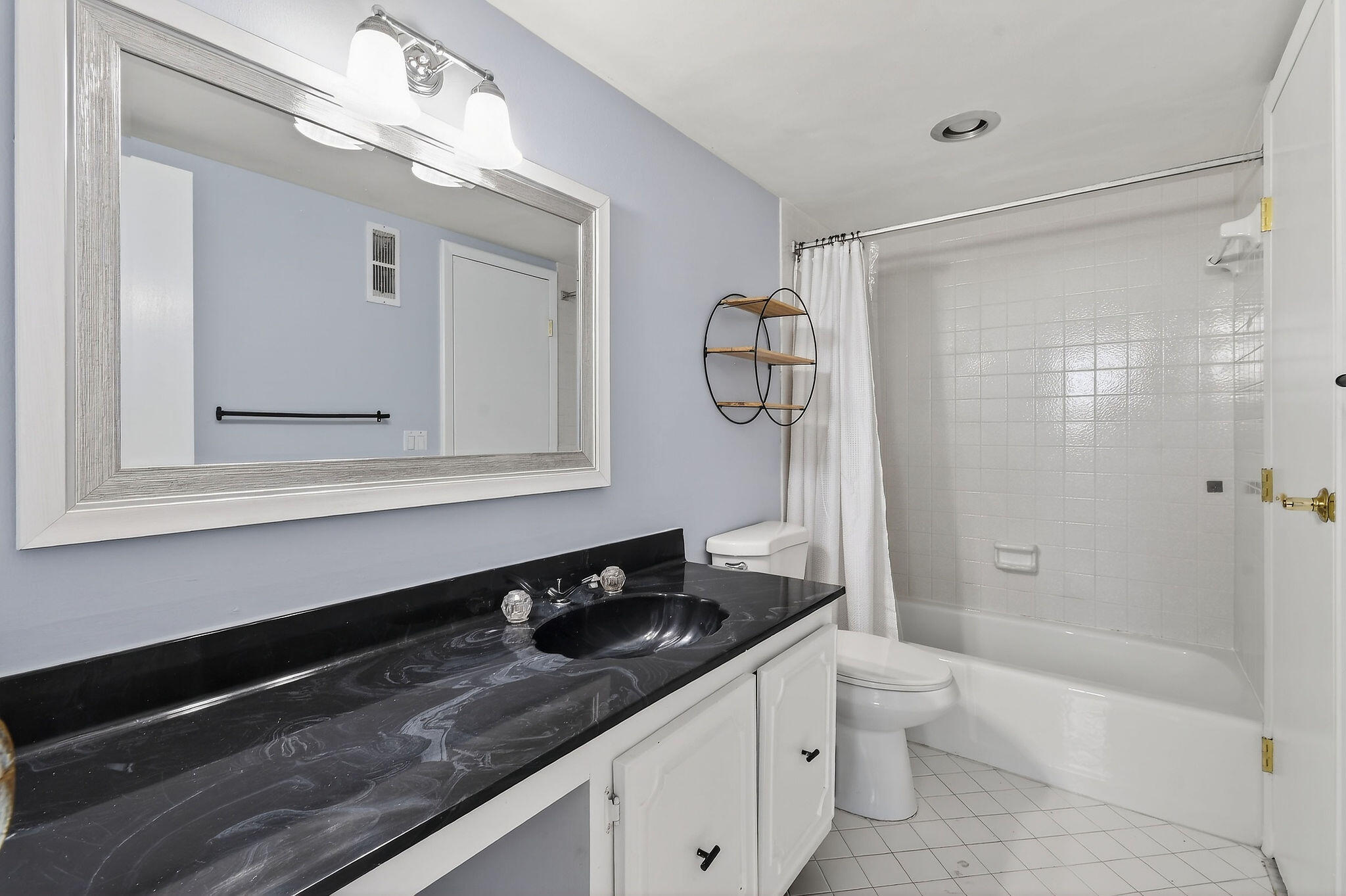 336 Golfview Road, Unit 408 North Palm Beach, FL 33408 - Photo 17 of 39 a bathroom with a granite countertop sink a toilet a mirror and shower