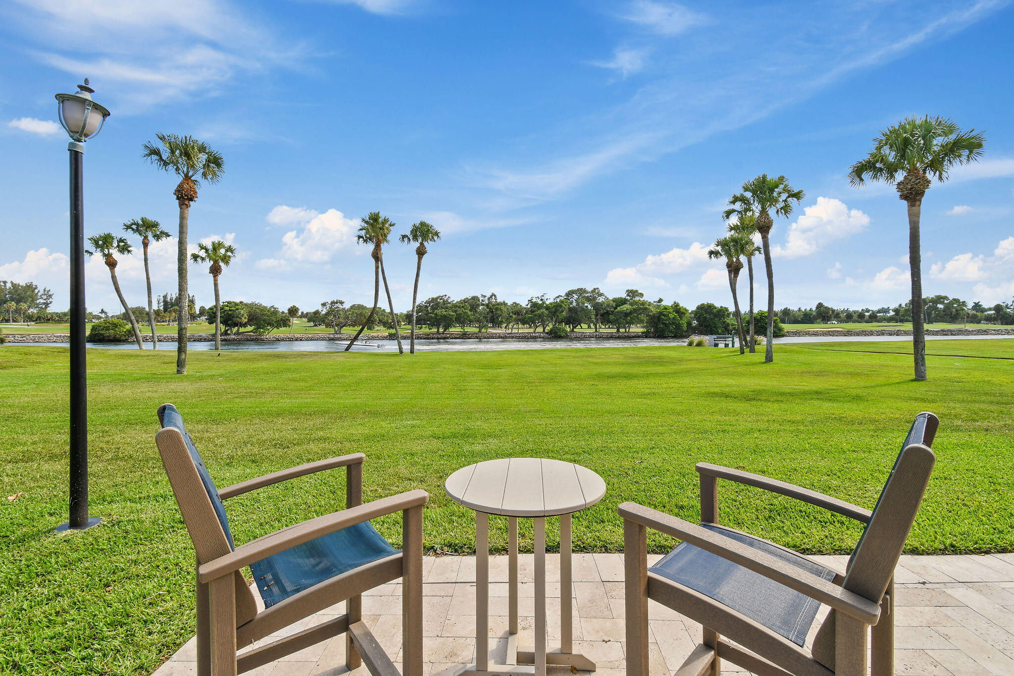 336 Golfview Road, Unit 408 North Palm Beach, FL 33408 - Photo 27 of 39 a view of a swimming pool and lounge chairs