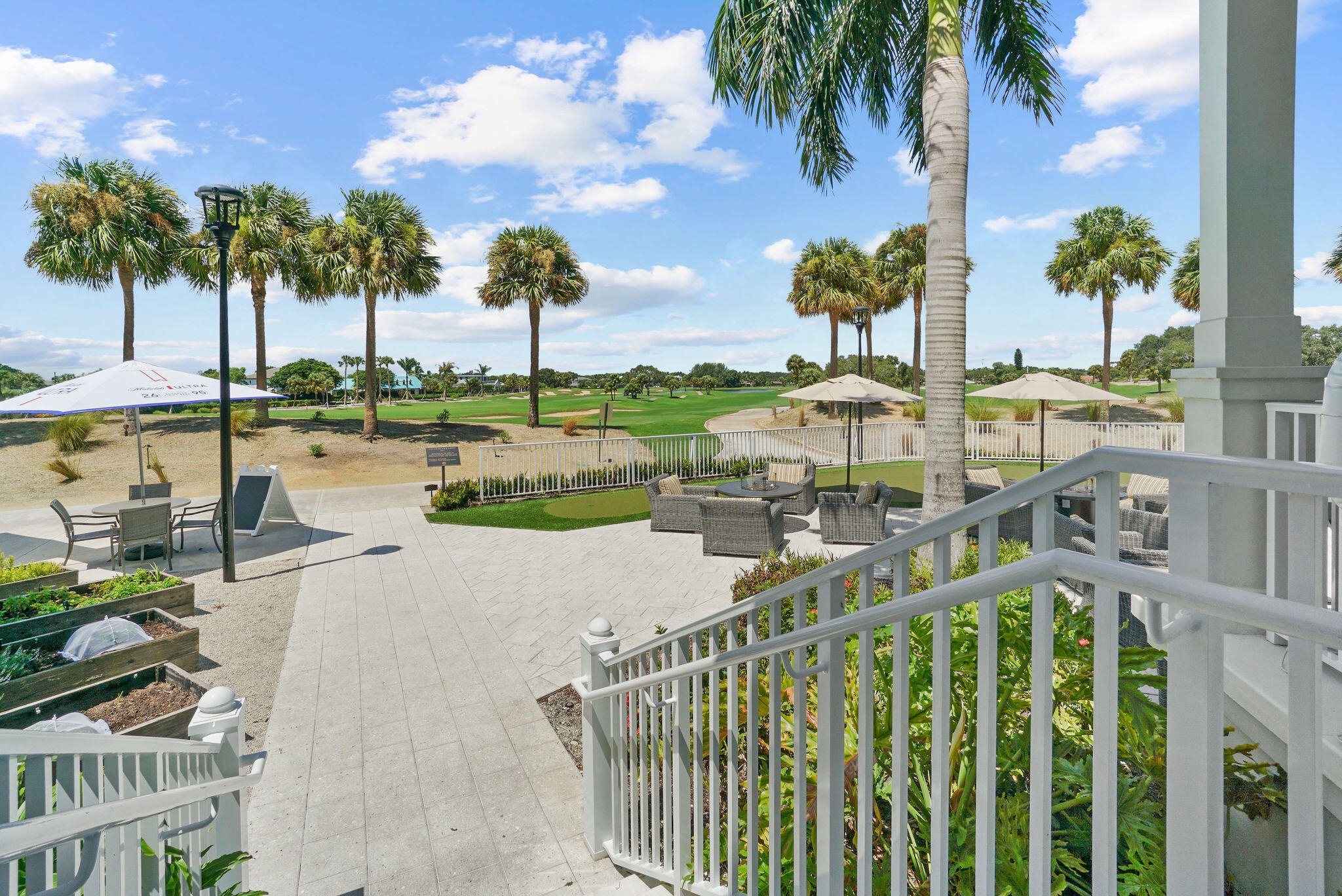 336 Golfview Road, Unit 408 North Palm Beach, FL 33408 - Photo 39 of 39 a view of a swimming pool with a table and chairs