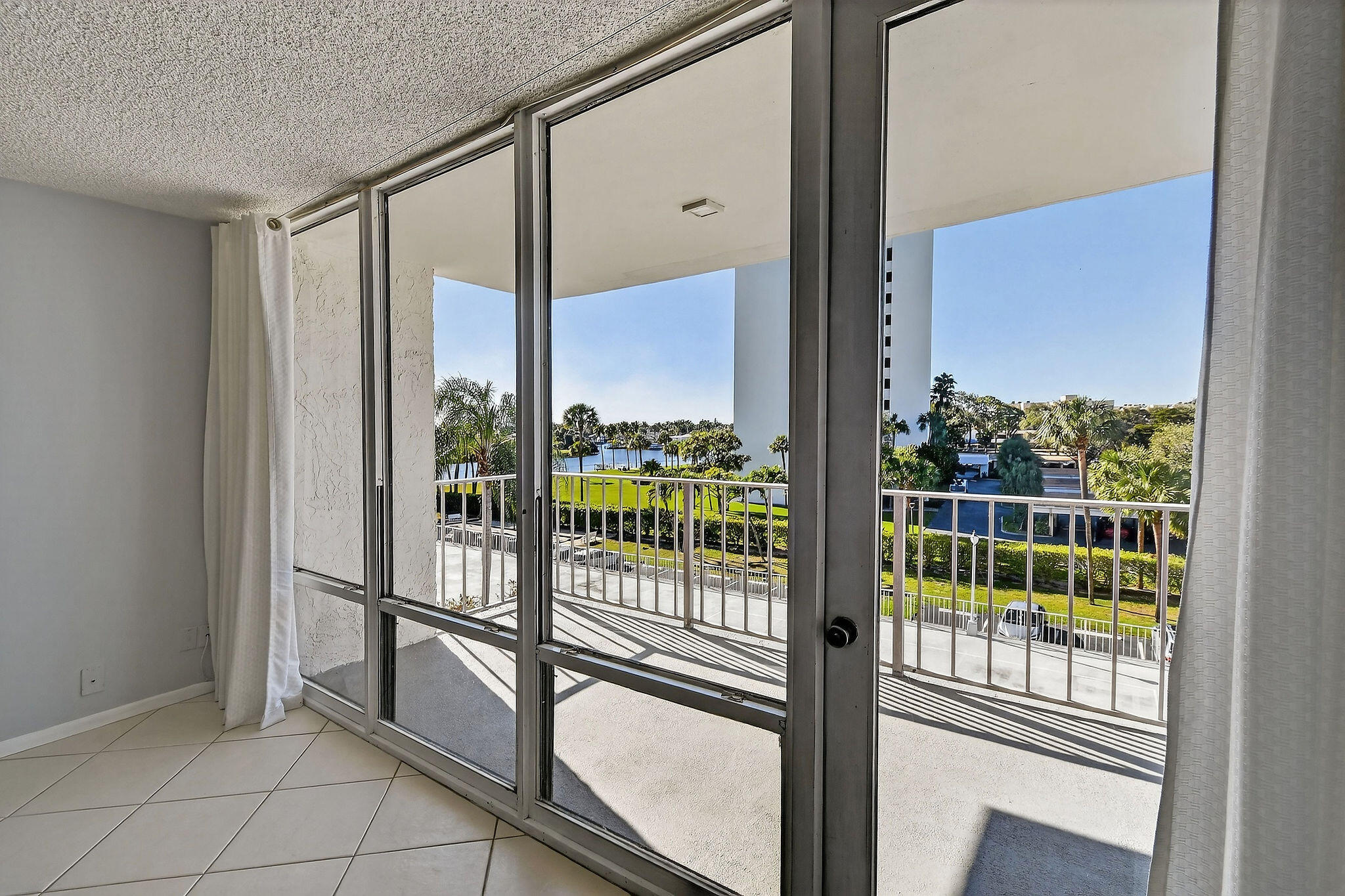 336 Golfview Road, Unit 408 North Palm Beach, FL 33408 - Photo 5 of 39 a view of a glass door with a balcony from a window