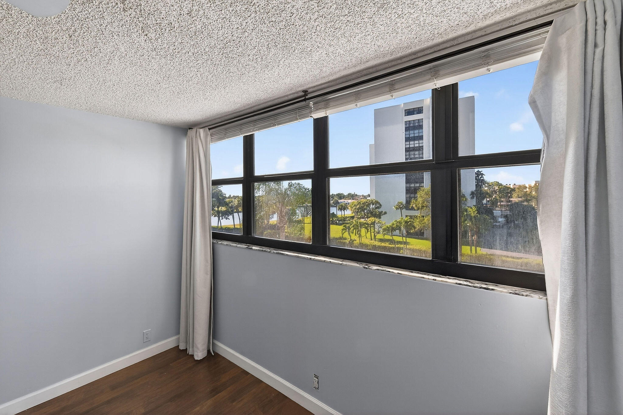 336 Golfview Road, Unit 408 North Palm Beach, FL 33408 - Photo 10 of 39 an empty room with wooden floor and a window