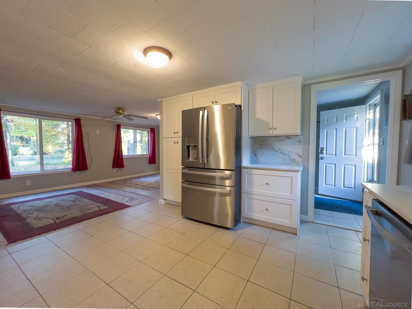 1123 Radov Road Gladwin, MI 48624 - Photo 7 of 29 Nice open space surrounding the kitchen, dining, and living rooms.