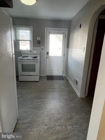a view of wooden floor and a chandelier in a room