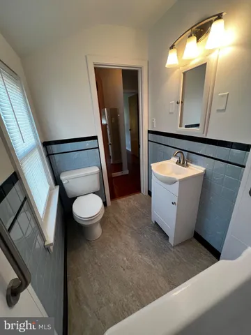 an empty room with wooden floors and window