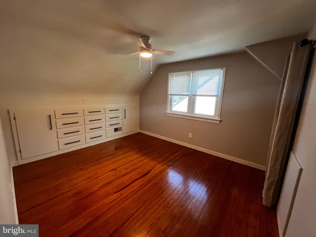 wooden floor in an empty room with a mirror
