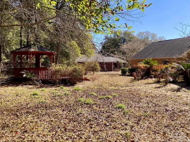 a view of a yard with snow on the road