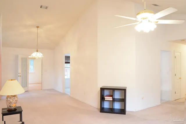 a view of a room with cabinet and chandelier fan