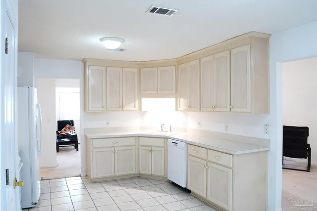 a kitchen with a sink cabinets and window
