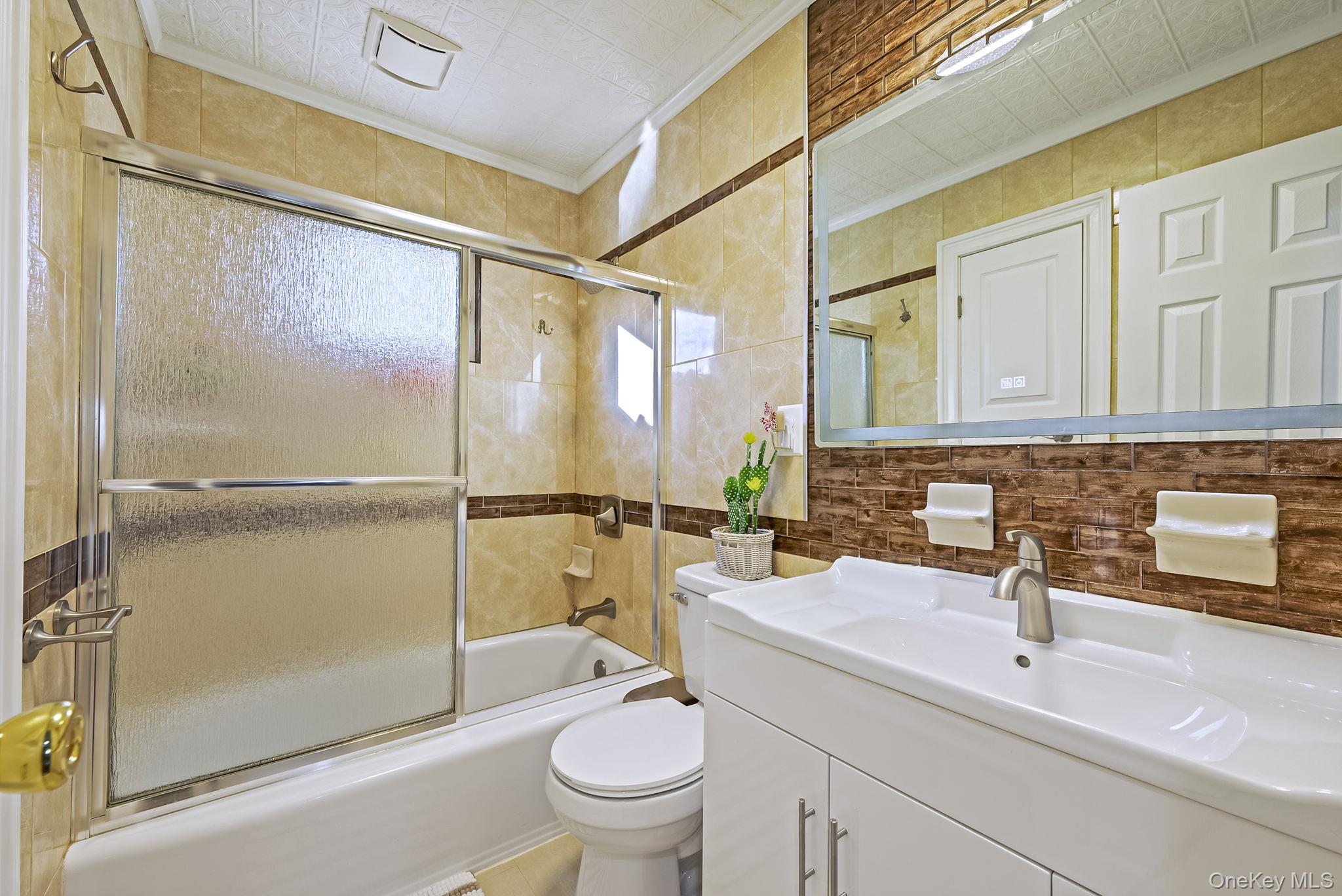 20 Howe Road Coram, NY 11727 - Photo 11 of 25 a bathroom with a sink toilet and shower