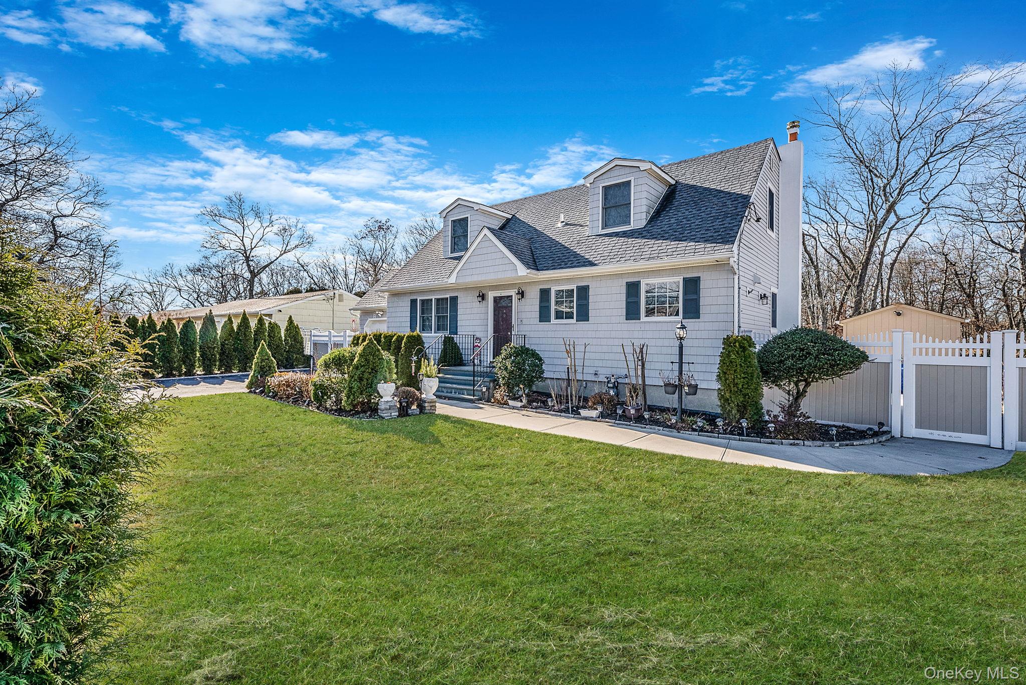 20 Howe Road Coram, NY 11727 - Photo 2 of 25 a front view of house with yard and green space