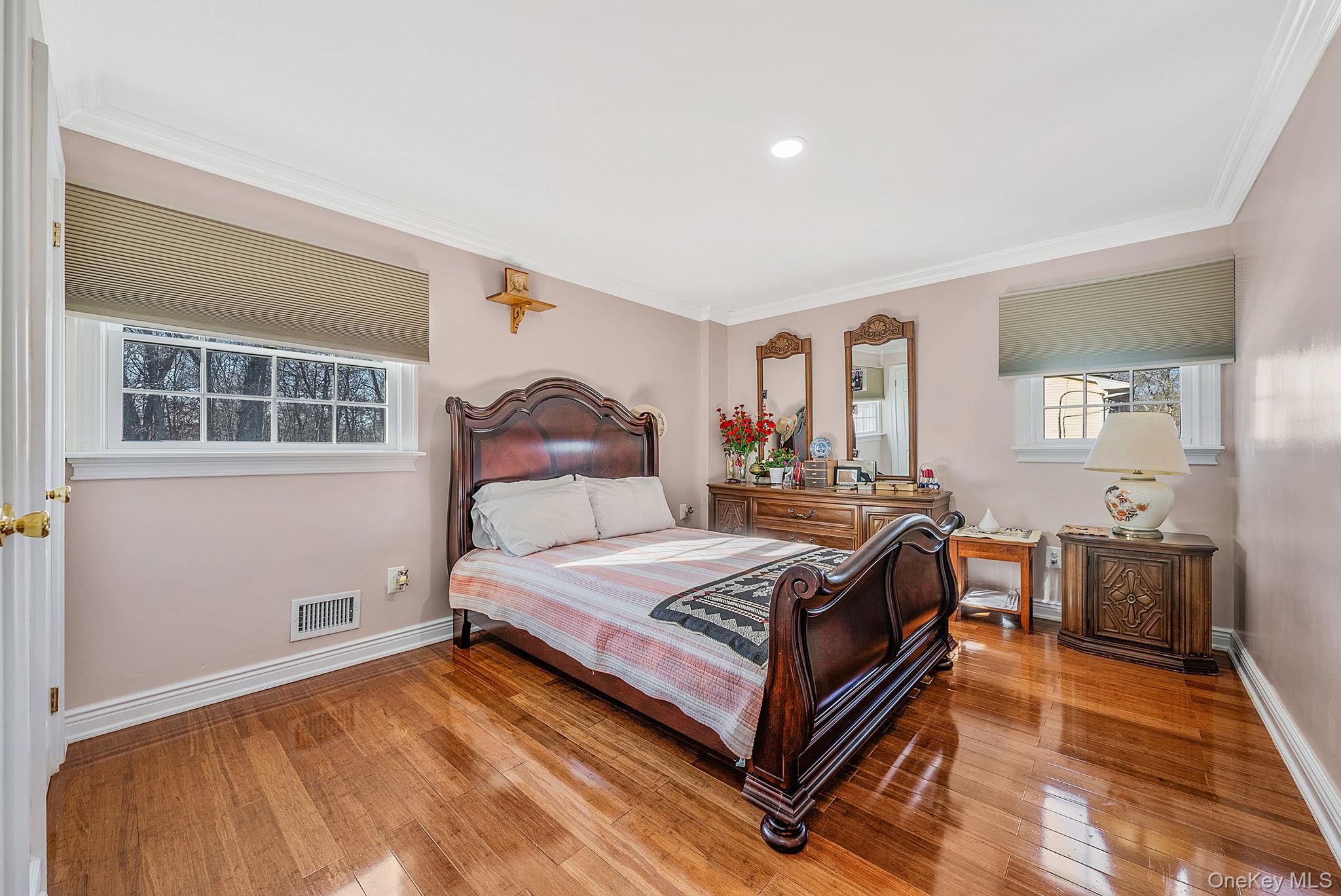 20 Howe Road Coram, NY 11727 - Photo 9 of 25 a bedroom with a bed wooden floor and window