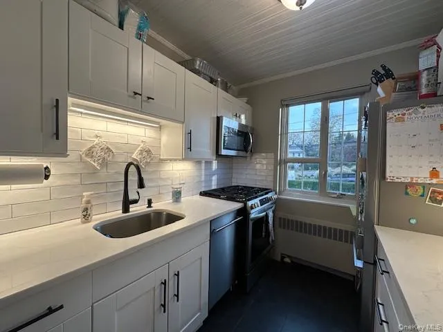 a kitchen with a sink a stove and cabinets