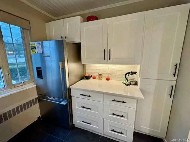 a kitchen with cabinets a washer and dryer