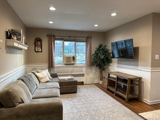 415 Main Street, Unit 101B Huntington, NY 11743 - Photo 6 of 10 a living room with furniture and a flat screen tv