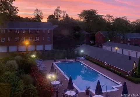 a view of a patio with a table and chairs under an umbrella