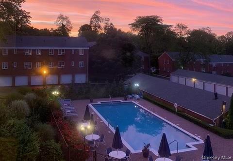 415 Main Street, Unit 101B Huntington, NY 11743 - Photo 10 of 10 a view of a patio with a table and chairs under an umbrella