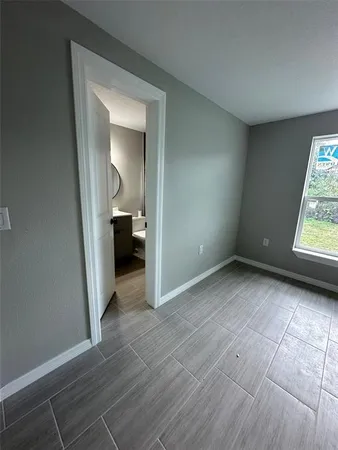 a bathroom with a sink mirror and toilet