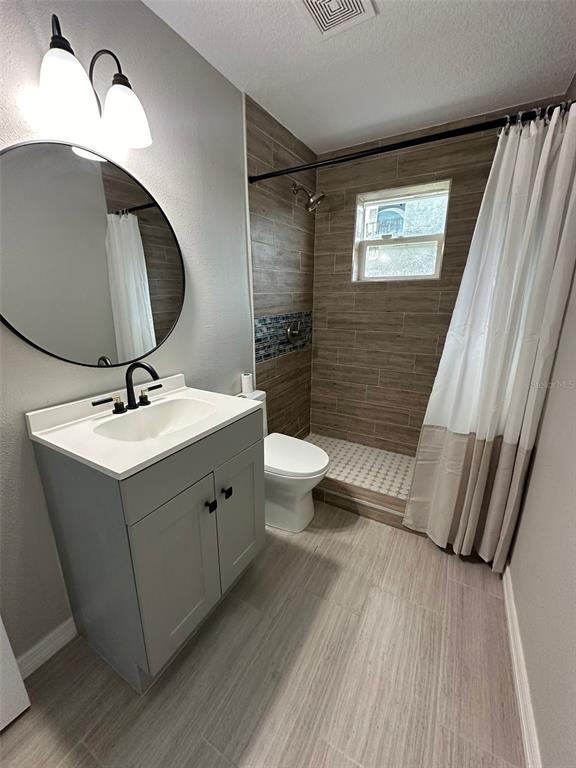 2015 Laurel Street Bartow, FL 33830 - Photo 12 of 18 a bathroom with a sink mirror and toilet