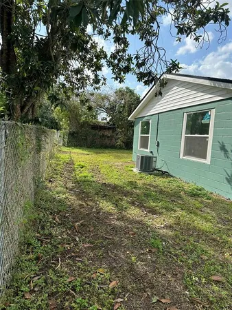 a house with green field in front of it