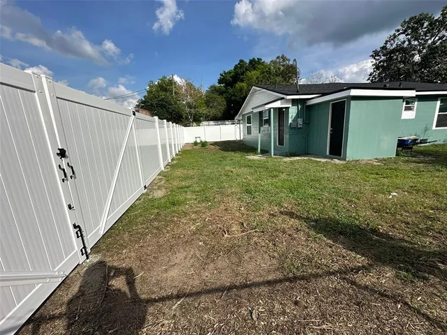 a view of a house with backyard and porch