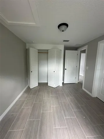 a view of a room with wooden floor and a window