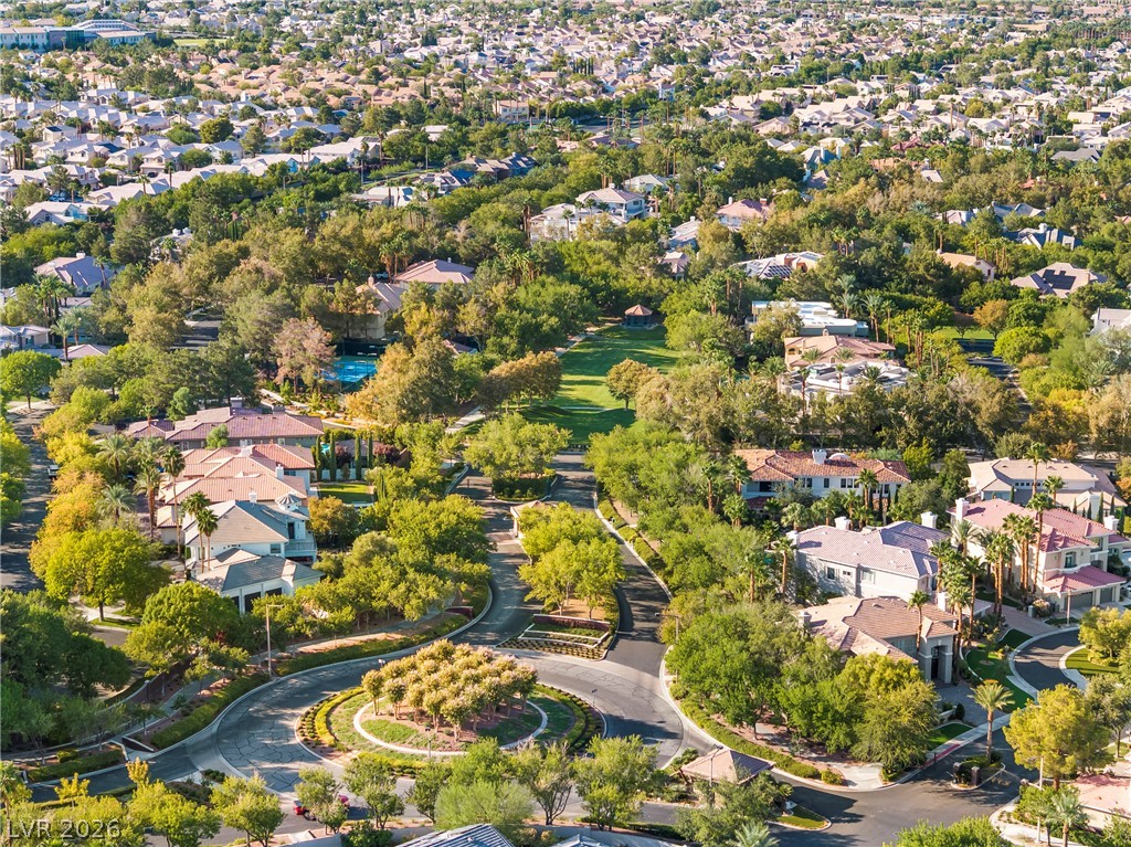 2000 Grouse Street Las Vegas, NV 89134 - Photo 76 of 89 An aerial perspective reveals a tree-lined neighborhood with winding roads and numerous residential properties.