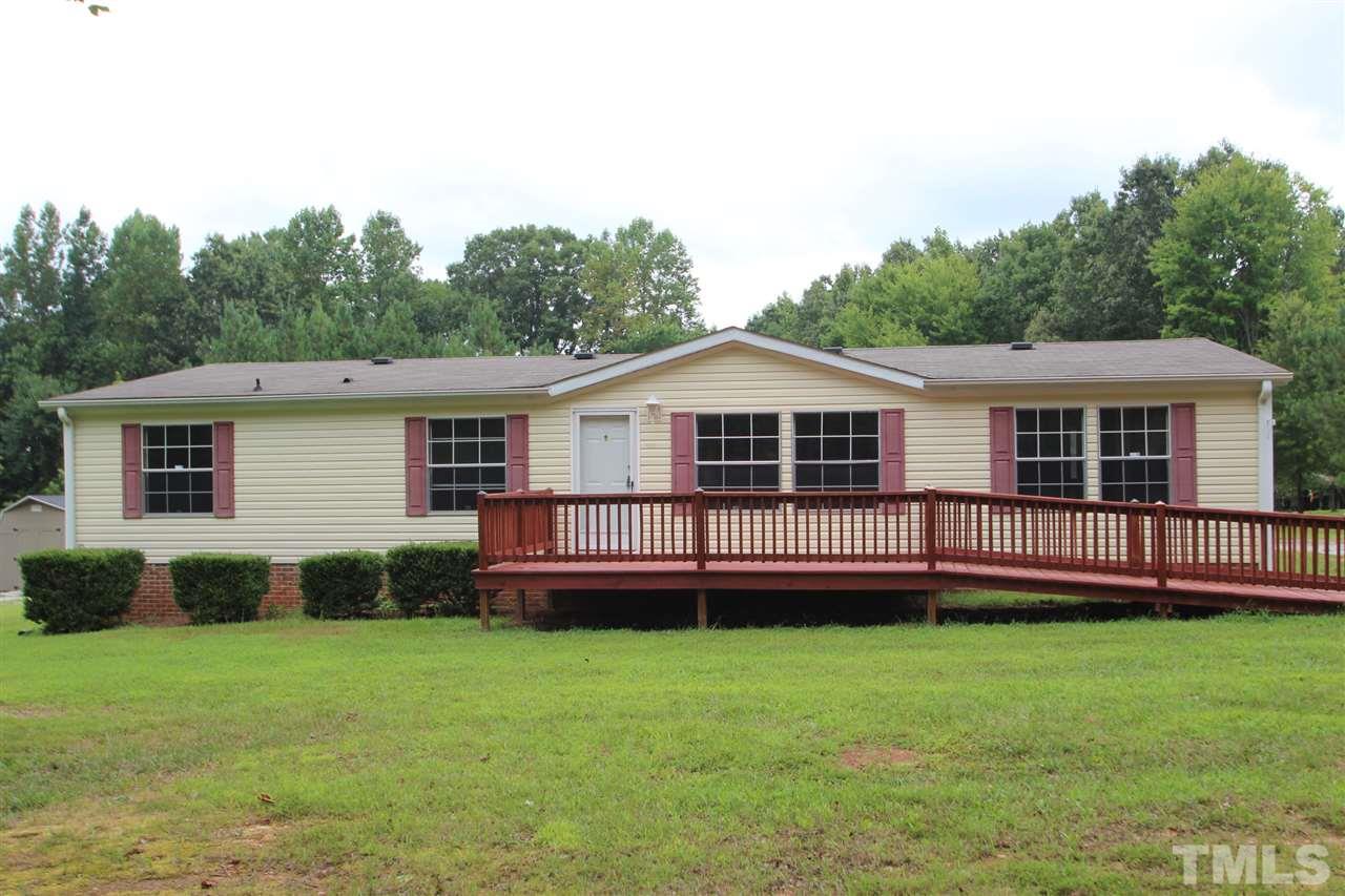 400 Neal's Store Road Roxboro, NC 27574 - Photo 1 of 15 a front view of a house with a garden