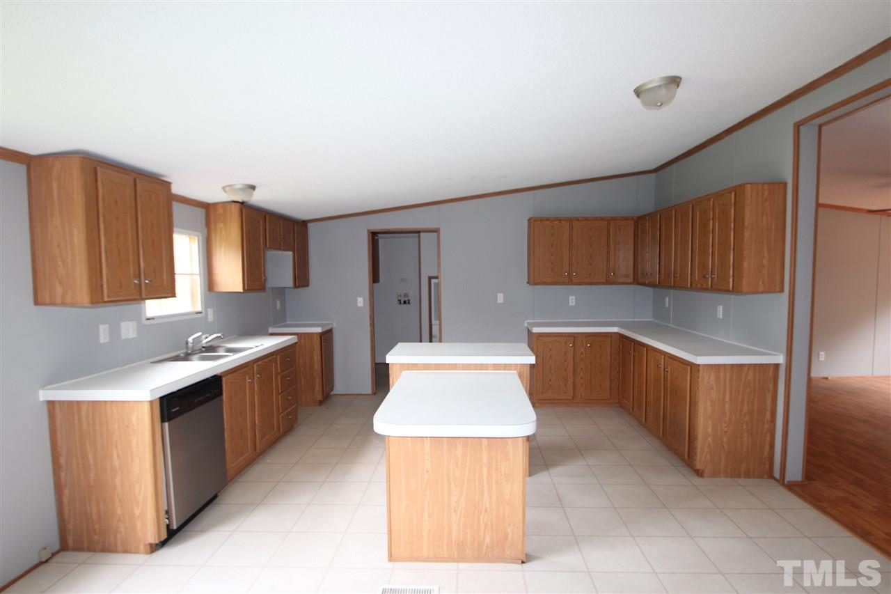 400 Neal's Store Road Roxboro, NC 27574 - Photo 3 of 15 a large kitchen with a large counter top space a sink stainless steel appliances and cabinets