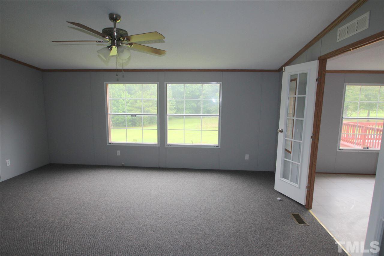 400 Neal's Store Road Roxboro, NC 27574 - Photo 4 of 15 an empty room with a window