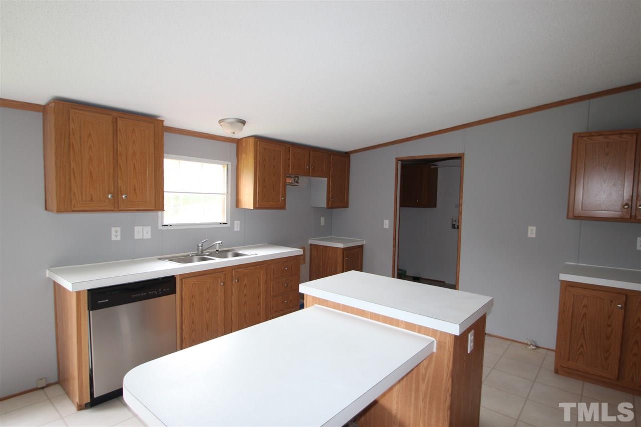 400 Neal's Store Road Roxboro, NC 27574 - Photo 7 of 15 a kitchen with a sink a stove and wooden floor