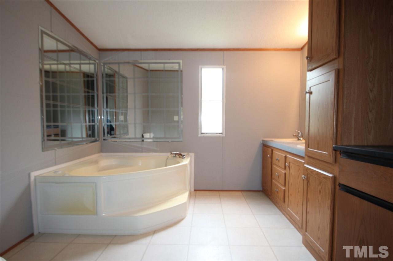 400 Neal's Store Road Roxboro, NC 27574 - Photo 9 of 15 a bathroom with a tub sink and mirror