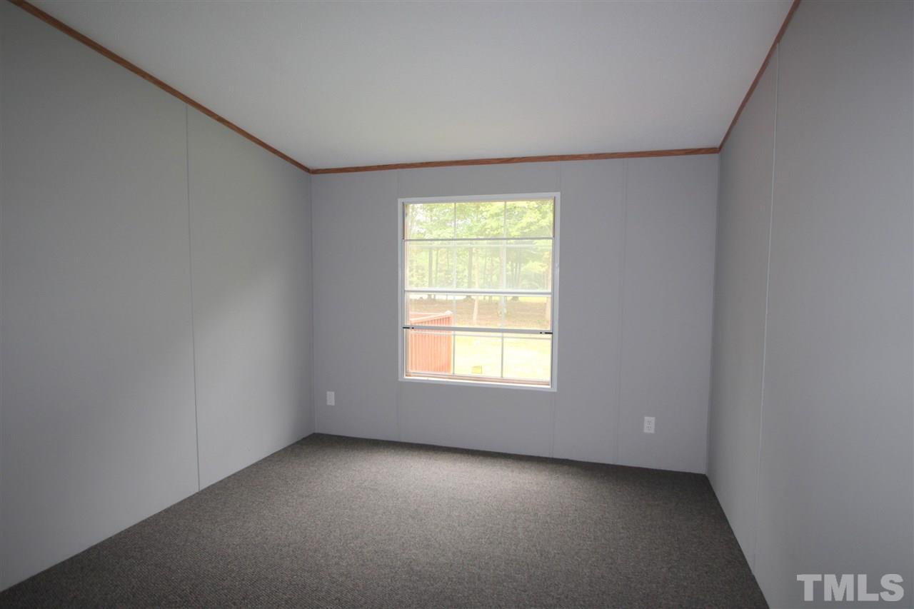 400 Neal's Store Road Roxboro, NC 27574 - Photo 10 of 15 an empty room with a window